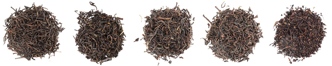 A pile of dry tea leaves with the tea pushed away in the middle to spell TEA.