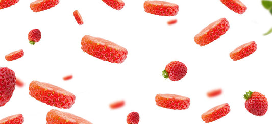 sliced strawberries floatinng in air on a white background